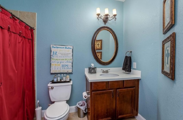 bathroom featuring vanity, toilet, a shower with shower curtain, and baseboards