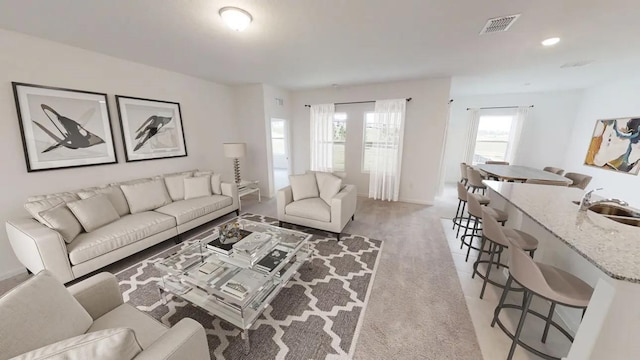 living area with light colored carpet