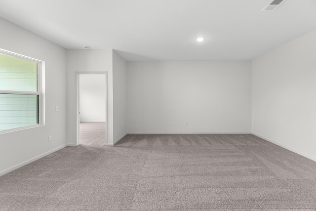 spare room featuring carpet flooring, baseboards, and recessed lighting