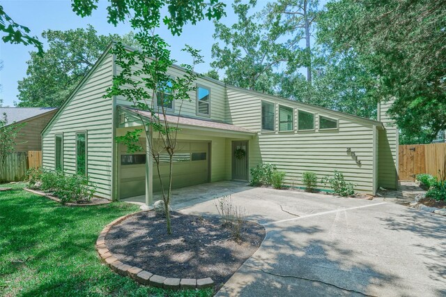 view of front of property with concrete driveway and an attached garage