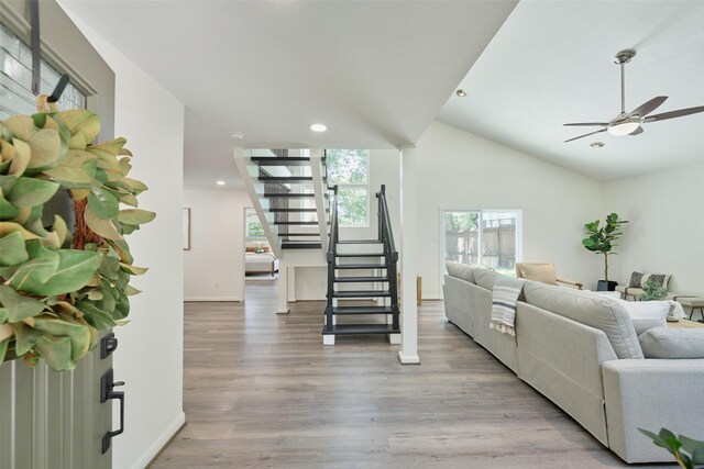 living area featuring stairway, light wood-style floors, recessed lighting, baseboards, and a ceiling fan