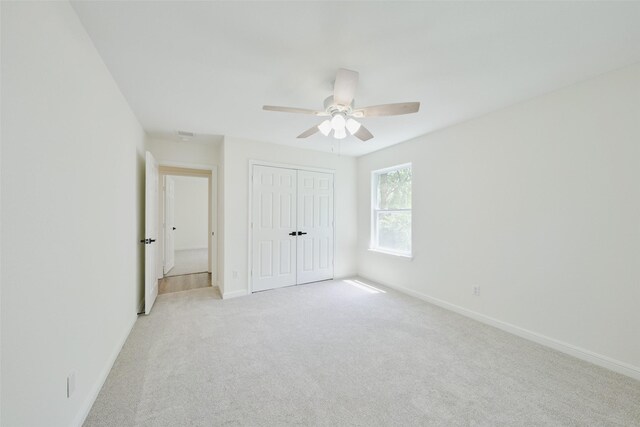 unfurnished bedroom with baseboards and light carpet