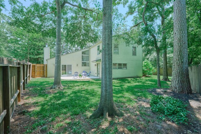 rear view of property featuring a patio area