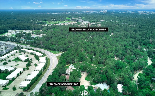 aerial view of property's location featuring a heavily wooded area