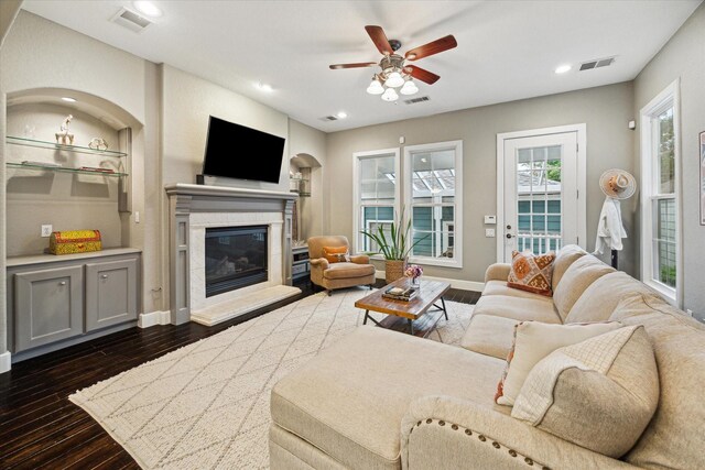 living room featuring dark wood-style flooring, a glass covered fireplace, a ceiling fan, and recessed lighting
