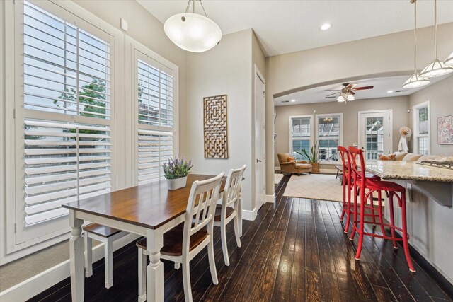 dining area featuring dark wood-style flooring, a ceiling fan, baseboards, plenty of natural light, and recessed lighting