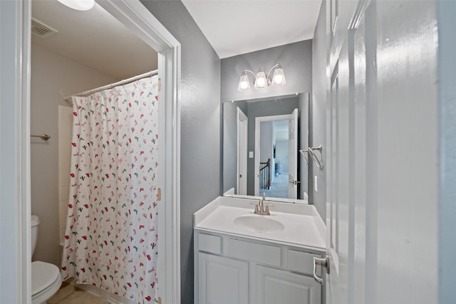 full bathroom with toilet, vanity, tile patterned floors, and curtained shower