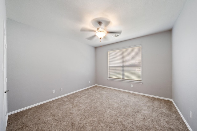 unfurnished room with carpet, ceiling fan, and baseboards