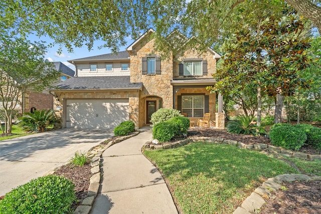view of front of house featuring stone siding, concrete driveway, a garage, and a front yard