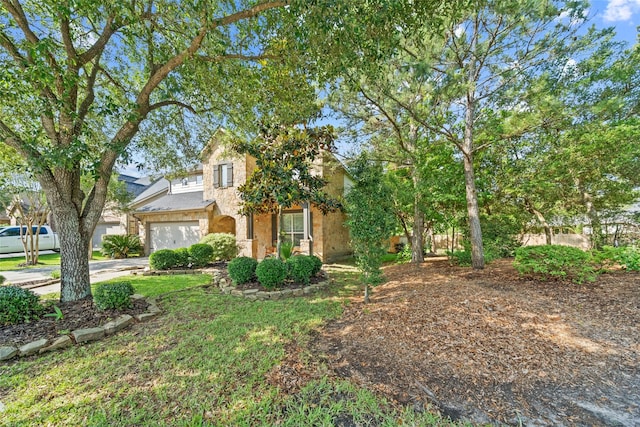 obstructed view of property featuring stone siding and concrete driveway
