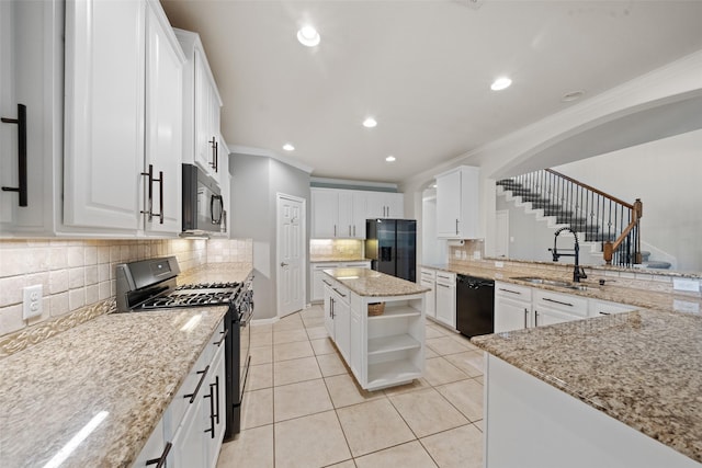 kitchen with black appliances, open shelves, crown molding, a sink, and arched walkways