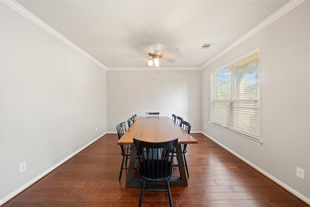 dining space featuring crown molding, dark wood-type flooring, baseboards, and a ceiling fan