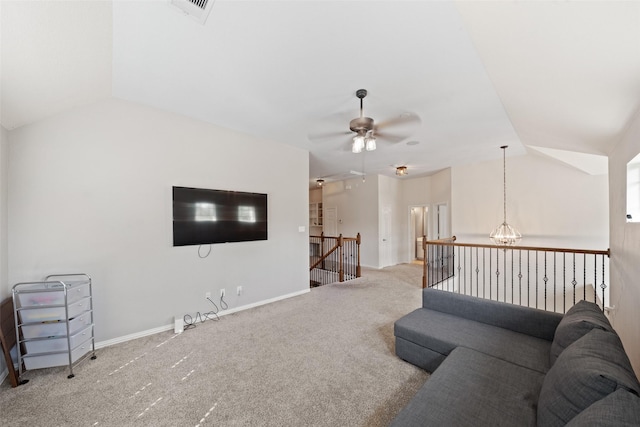 living area with vaulted ceiling, carpet, ceiling fan, attic access, and baseboards