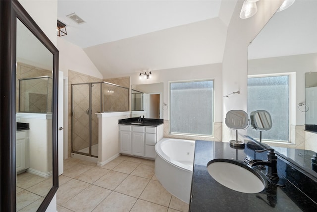 bathroom with healthy amount of natural light, vaulted ceiling, a stall shower, tile patterned floors, and a bath
