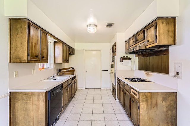 kitchen featuring white appliances, a sink, light countertops, and under cabinet range hood