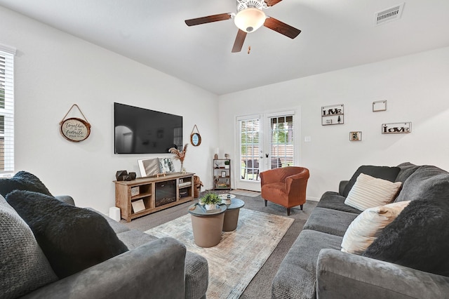 10707 Lost Maples Dr, Cleveland, TX 77328 - living room with light carpet and a ceiling fan