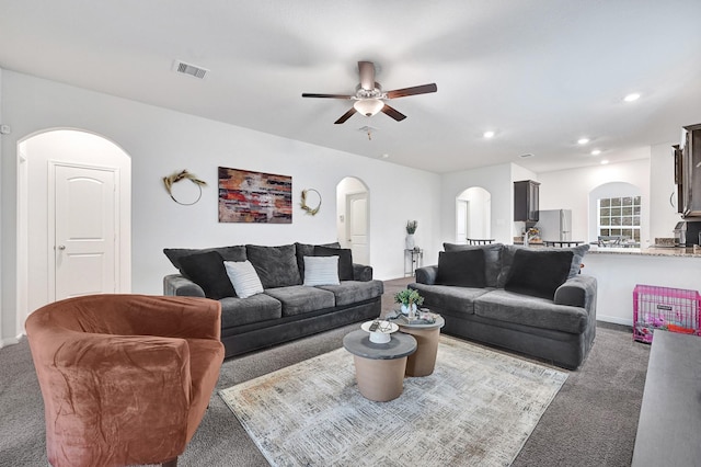 10707 Lost Maples Dr, Cleveland, TX 77328 - living room with arched walkways, carpet flooring, a ceiling fan, and recessed lighting