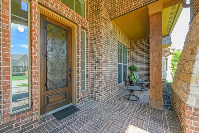23615 Dolci Ln, Richmond, TX 77406 - property entrance featuring a porch and brick siding