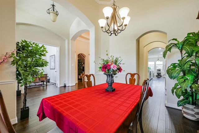 23615 Dolci Ln, Richmond, TX 77406 - dining area featuring a chandelier, wood finished floors, and arched walkways