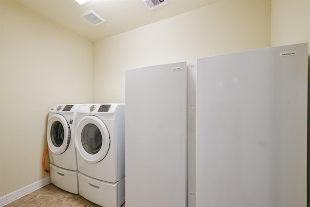 23615 Dolci Ln, Richmond, TX 77406 - laundry area featuring washer and dryer and baseboards