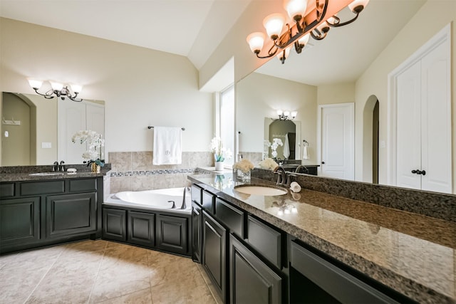 23615 Dolci Ln, Richmond, TX 77406 - bathroom featuring a chandelier, two vanities, and a bath