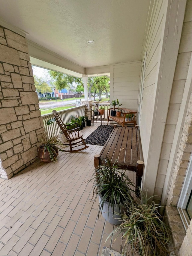 wooden terrace with a porch