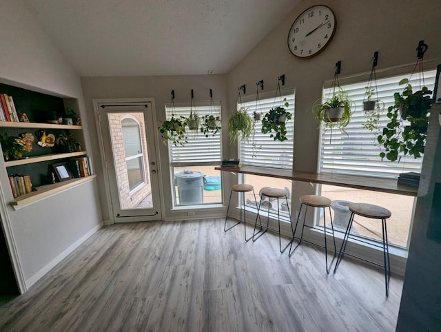 sunroom / solarium featuring lofted ceiling