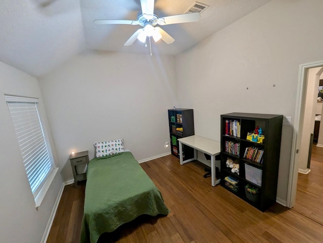 bedroom with vaulted ceiling, wood finished floors, baseboards, and a ceiling fan