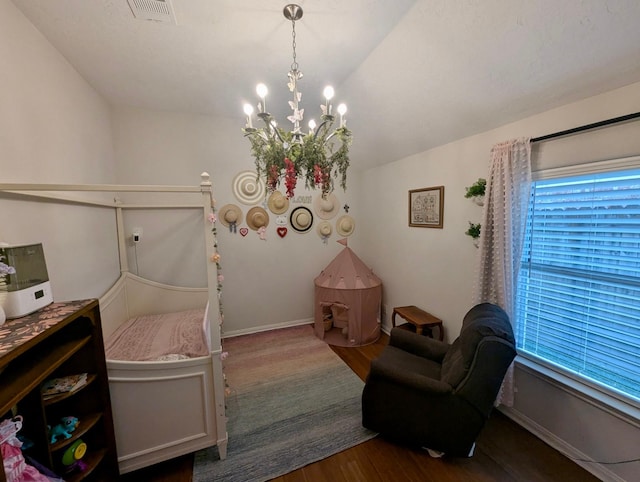 bedroom with dark wood-style floors, a chandelier, and baseboards