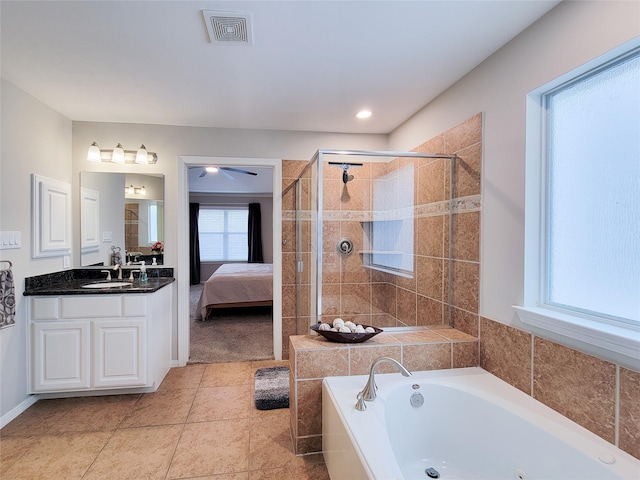1241 Prince St, Houston, TX 77008 - full bathroom with a tub with jets, vanity, a stall shower, connected bathroom, and tile patterned floors