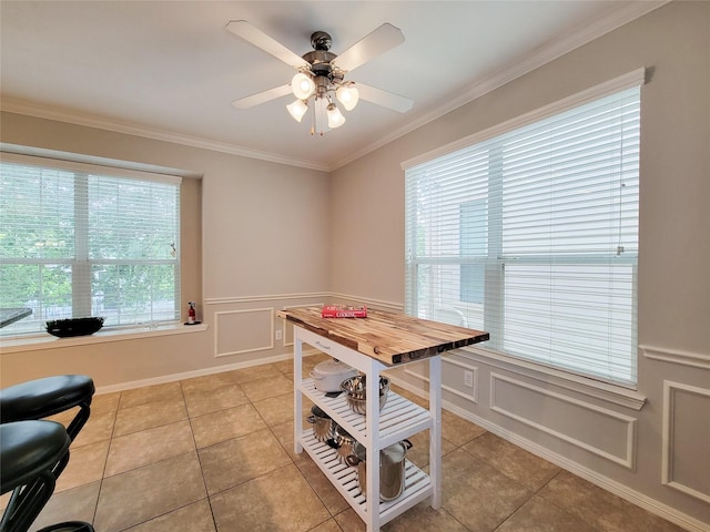 1241 Prince St, Houston, TX 77008 - dining space featuring a ceiling fan, ornamental molding, a decorative wall, light tile patterned floors, and a wainscoted wall