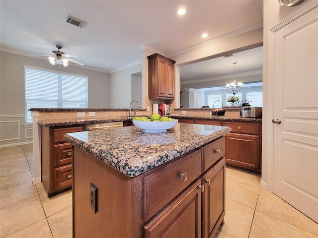 1241 Prince St, Houston, TX 77008 - kitchen featuring a kitchen island, light tile patterned floors, ornamental molding, a peninsula, and recessed lighting