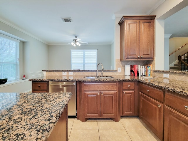 1241 Prince St, Houston, TX 77008 - kitchen with stainless steel dishwasher, a sink, decorative backsplash, dark stone counters, and ornamental molding