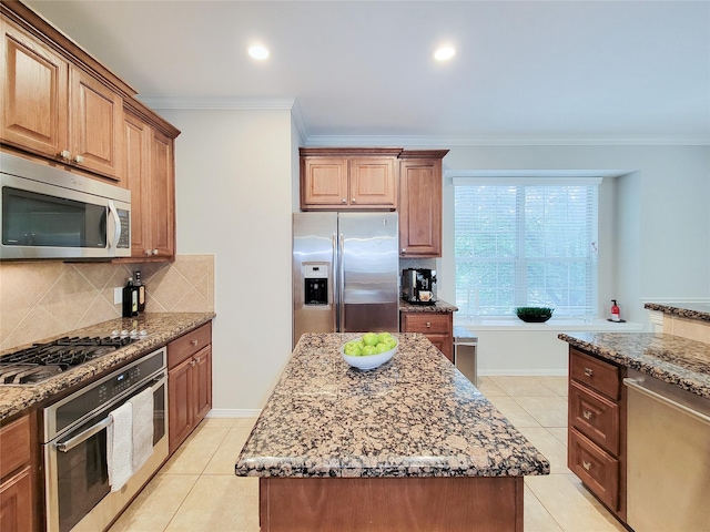 1241 Prince St, Houston, TX 77008 - kitchen with appliances with stainless steel finishes, dark stone counters, crown molding, tasteful backsplash, and light tile patterned floors