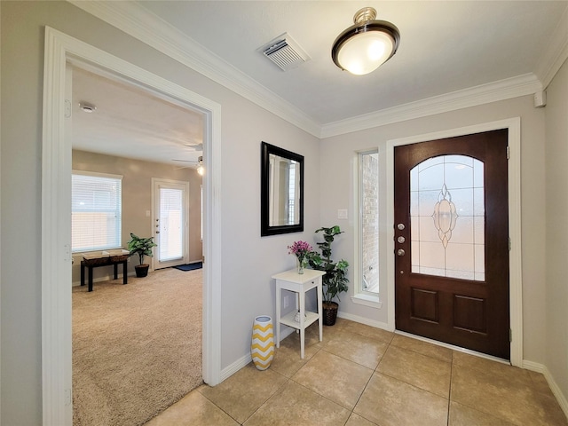 1241 Prince St, Houston, TX 77008 - entrance foyer featuring ornamental molding, light tile patterned flooring, baseboards, and light carpet