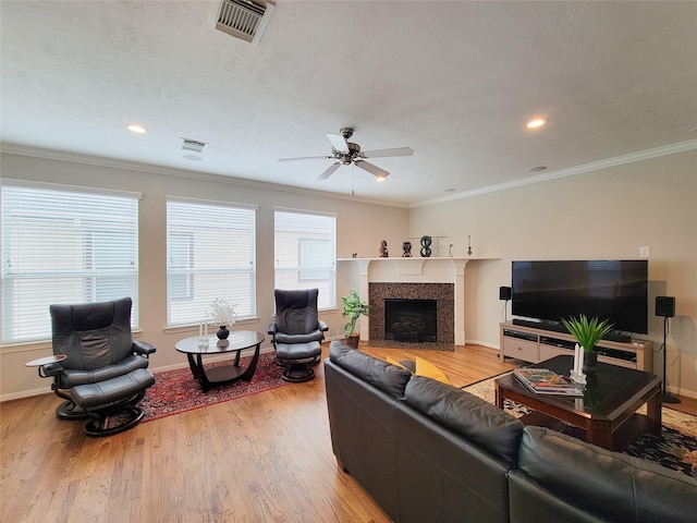 1241 Prince St, Houston, TX 77008 - living area featuring light wood finished floors, ceiling fan, a fireplace, baseboards, and ornamental molding