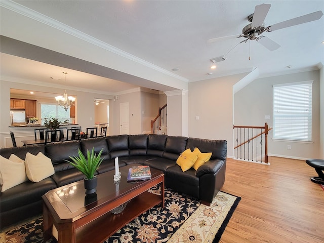 1241 Prince St, Houston, TX 77008 - living room with ceiling fan, light wood-style floors, a chandelier, crown molding, and baseboards
