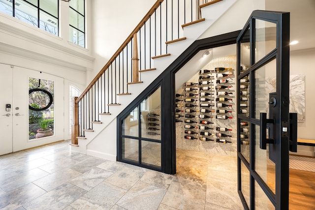 3113 Saddlebrook Ln, Katy, TX 77494 - wine area featuring a high ceiling, baseboards, and stone finish flooring