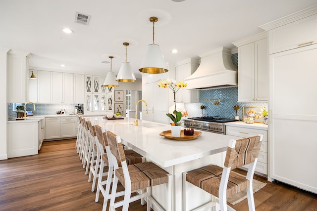 3113 Saddlebrook Ln, Katy, TX 77494 - kitchen with custom exhaust hood, a sink, decorative backsplash, dark wood finished floors, and recessed lighting