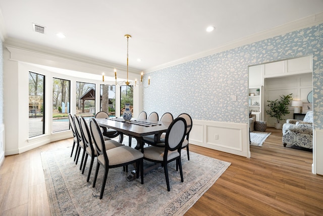 3113 Saddlebrook Ln, Katy, TX 77494 - dining space with ornamental molding, a chandelier, wood finished floors, recessed lighting, and wallpapered walls