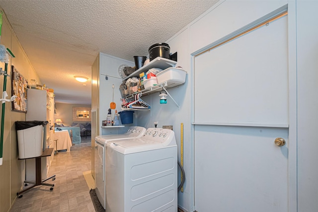 333 9th St, San Leon, TX 77539 - clothes washing area with washer and clothes dryer and a textured ceiling