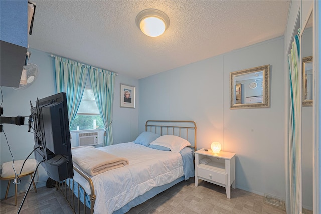 333 9th St, San Leon, TX 77539 - bedroom featuring a textured ceiling and cooling unit