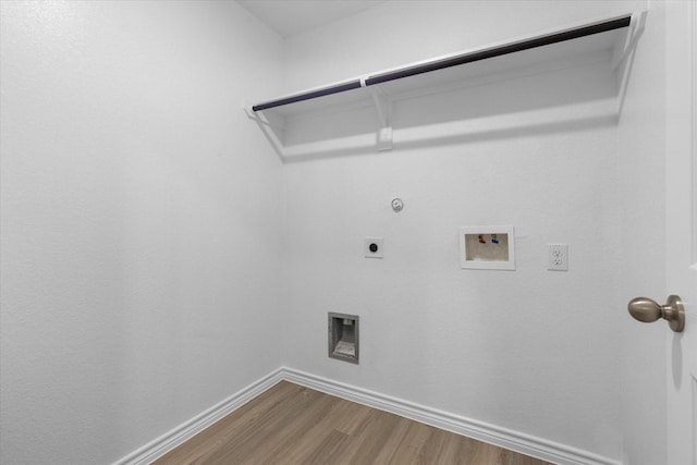 laundry area featuring wood finished floors, hookup for a gas dryer, electric dryer hookup, washer hookup, and baseboards