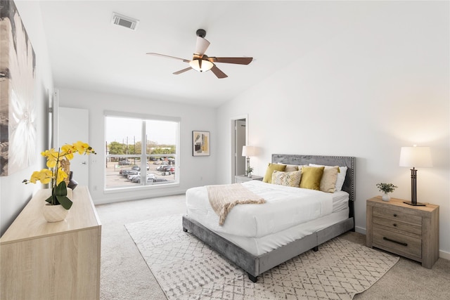 carpeted bedroom featuring a ceiling fan and vaulted ceiling