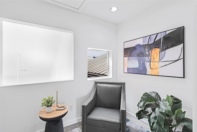 living area with baseboards and recessed lighting