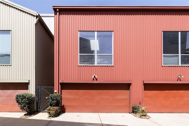 view of front facade featuring an attached garage and a gate