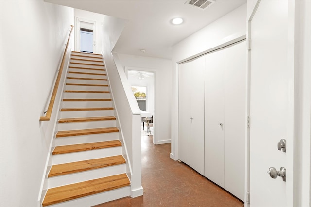 stairway featuring concrete floors and recessed lighting