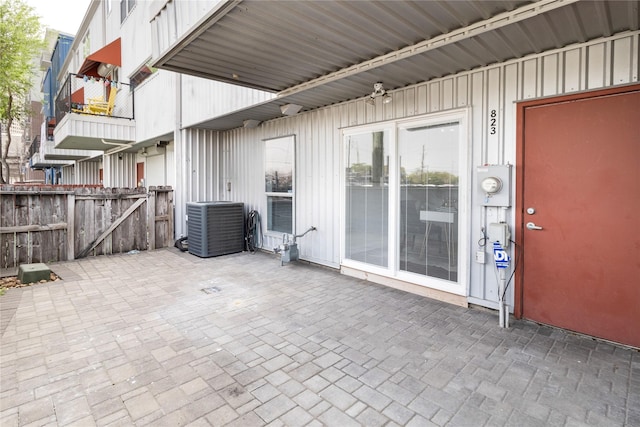 view of patio featuring cooling unit, a gate, and fence