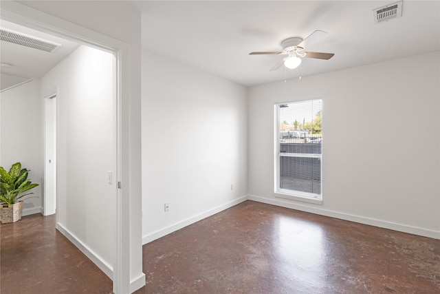 empty room featuring finished concrete floors, ceiling fan, and baseboards