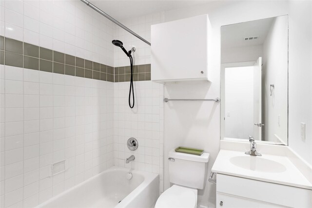 bathroom featuring vanity, toilet, and shower / tub combination